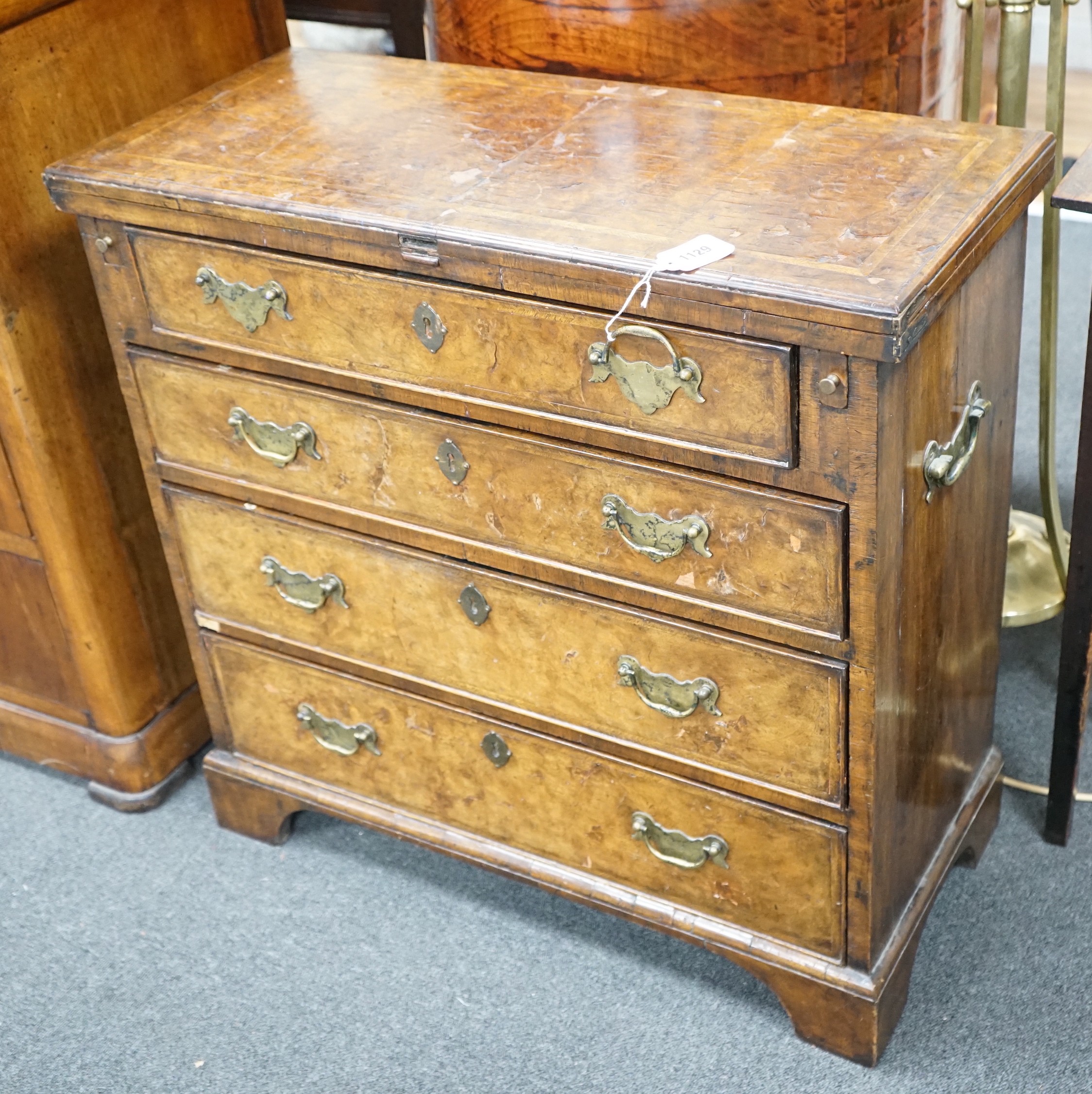 An early 18th century style feather banded walnut bachelor's chest, width 76cm, depth 34cm, height 75cm